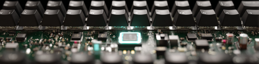 Panoramic close-up of a mechanical keyboard’s exposed green PCB, featuring a glowing cyan central chip and visible key switch solder points, showcasing advanced keyboard hardware design