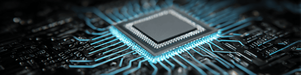 Panoramic macro close-up of a CPU processor chip on a black circuit board with glowing blue data traces, representing advanced computing, high-speed data transfer and semiconductor technology.