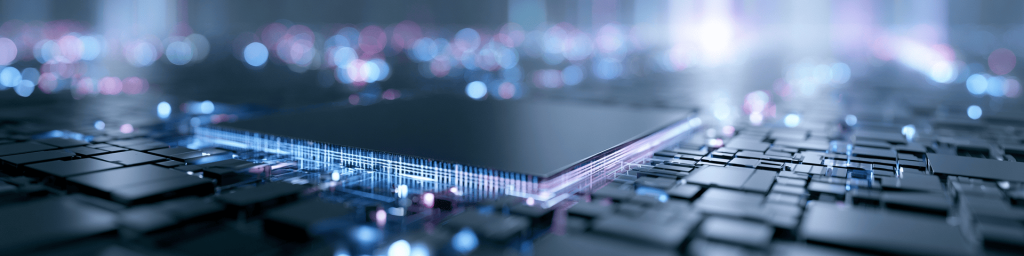 Panoramic macro view of a glowing microprocessor with blue and pink light trails on a dark circuit board, representing advanced computing power and next-gen semiconductor tech.