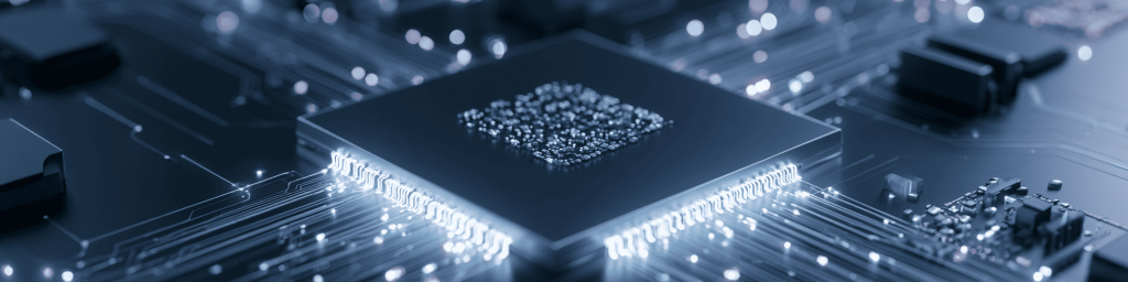 Panoramic close-up of a BGA microchip with glowing solder balls and circuit traces on a dark motherboard, representing advanced semiconductor packaging and high-speed data transmission.