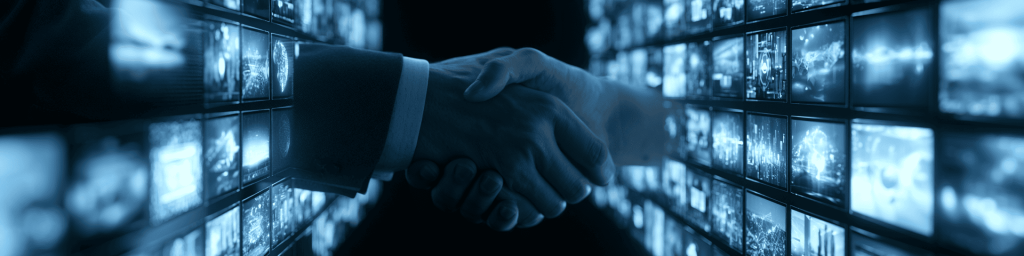 Close-up handshake between business partners with blue tones and glowing tech screens in the background.