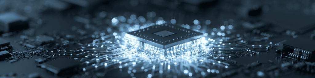 Low-angle macro of a glowing BGA chip on a dark PCB, cool blue monochrome, soft bokeh.