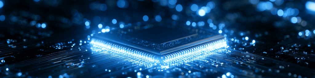 Panoramic tech banner of illuminated processor chip pins on circuit board with soft blue bokeh lights