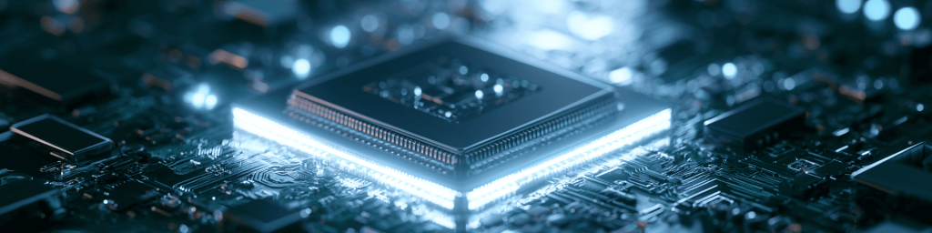 Wide banner view of glowing AI processor chip mounted on intricate circuit board