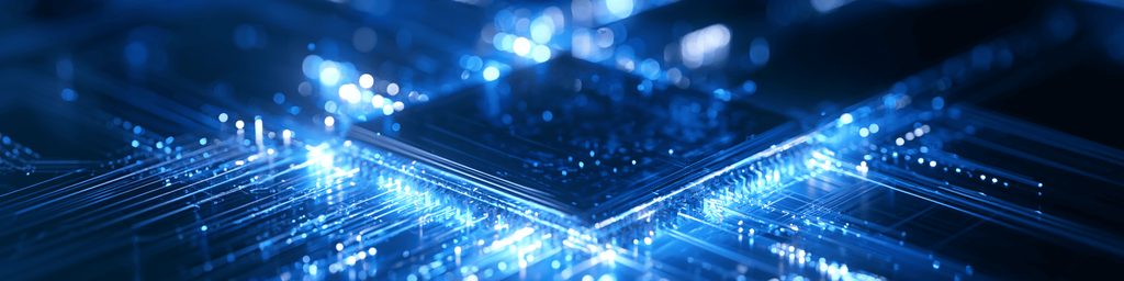 Wide banner view of glowing blue photonic integrated chip with light circuit traces